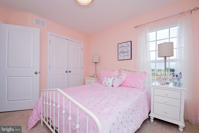 carpeted bedroom with a closet