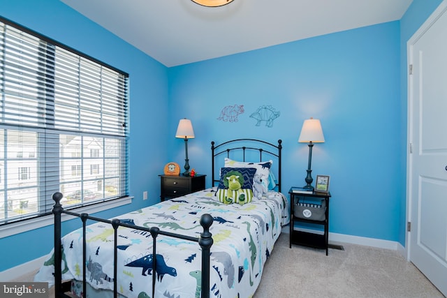 bedroom featuring light colored carpet