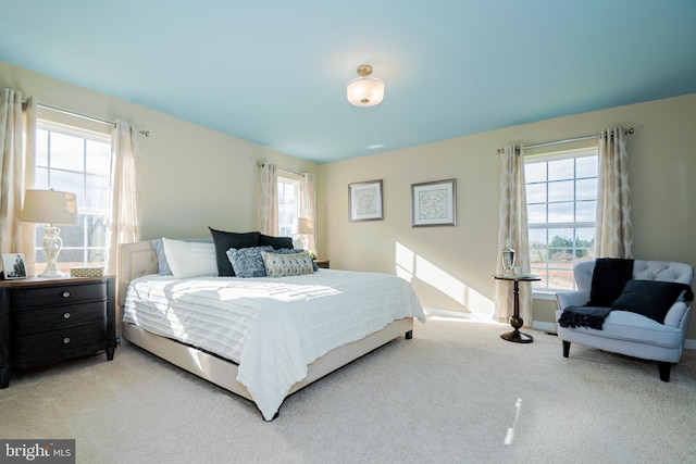 bedroom featuring light carpet