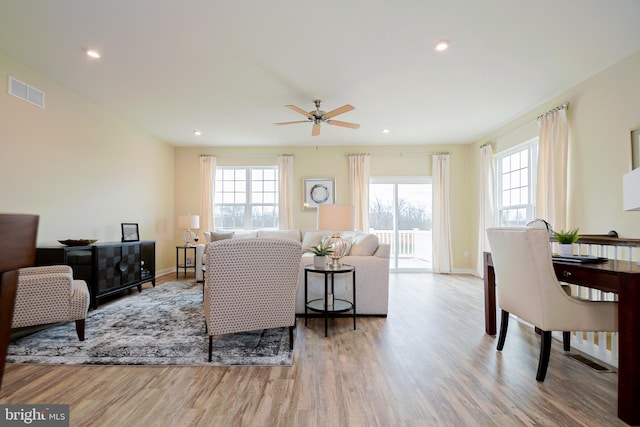 living room with ceiling fan and light hardwood / wood-style floors