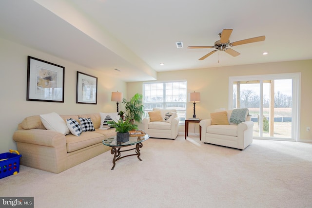 living room with ceiling fan and light colored carpet