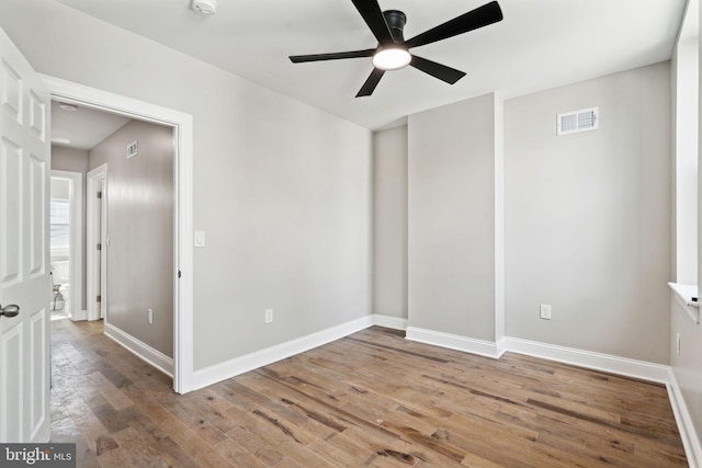 unfurnished room featuring hardwood / wood-style flooring and ceiling fan