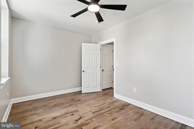 spare room with ceiling fan and hardwood / wood-style flooring