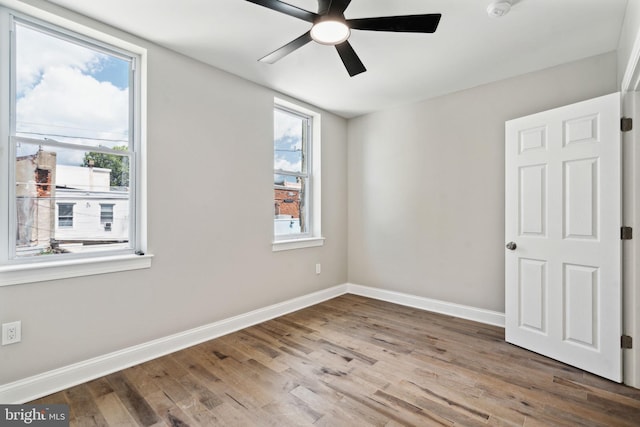 spare room with ceiling fan and hardwood / wood-style floors