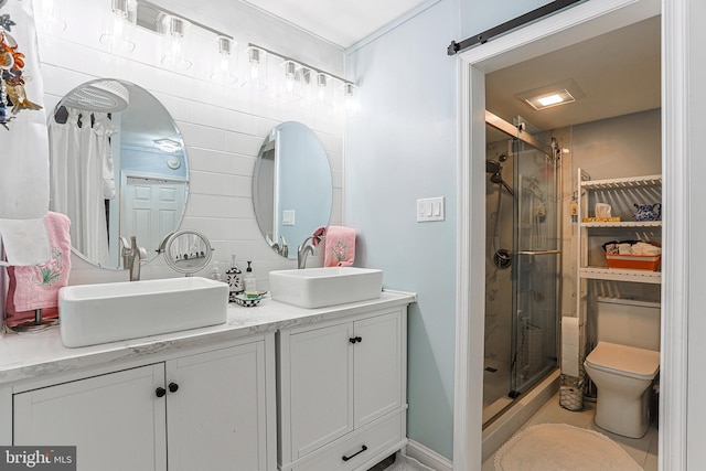 bathroom with toilet, an enclosed shower, and dual bowl vanity