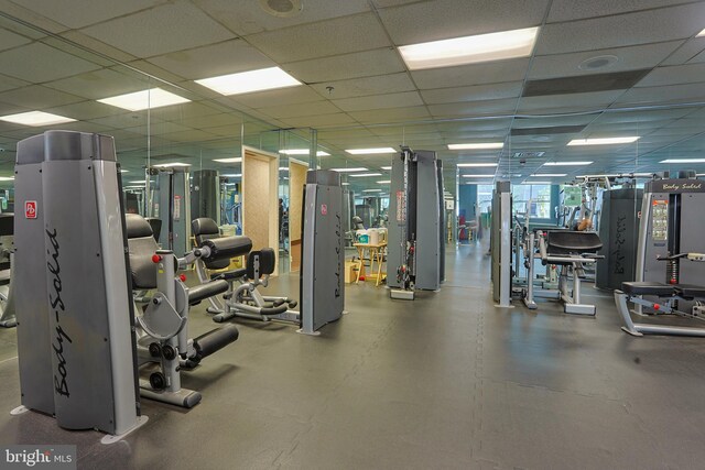 workout area with a paneled ceiling