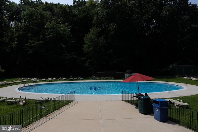 view of pool with a yard