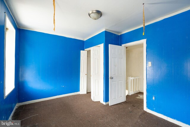 unfurnished bedroom with carpet floors and ornamental molding