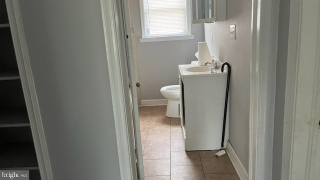 bathroom with tile patterned flooring, vanity, and toilet