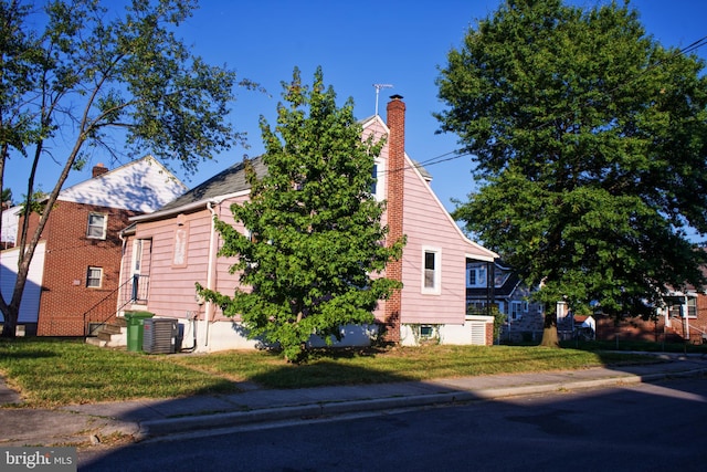 view of home's exterior with central AC