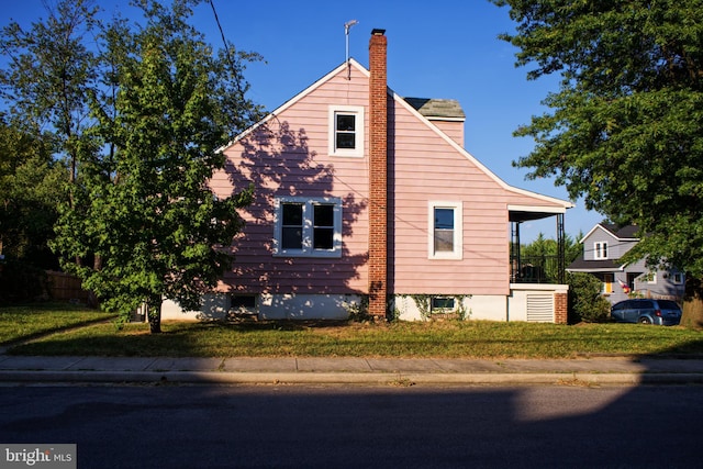 view of property exterior featuring a lawn