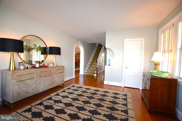 interior space with multiple windows and hardwood / wood-style floors