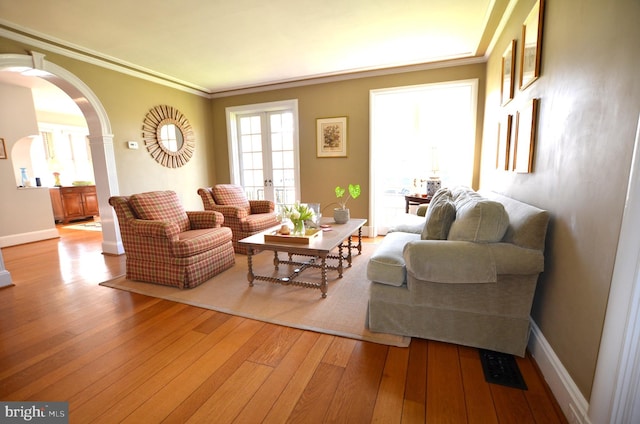 living room featuring crown molding and hardwood / wood-style flooring