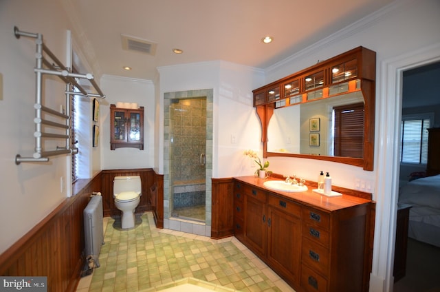 bathroom featuring radiator heating unit, walk in shower, toilet, crown molding, and vanity