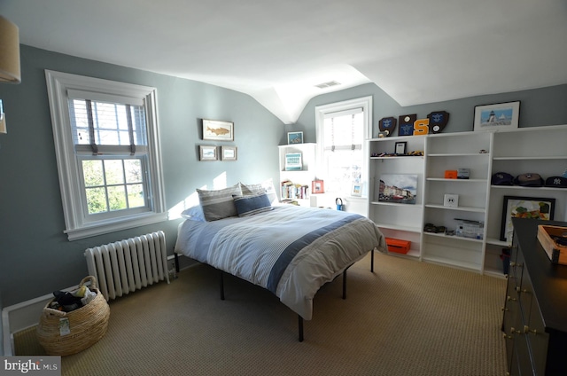 carpeted bedroom with lofted ceiling, radiator, and multiple windows