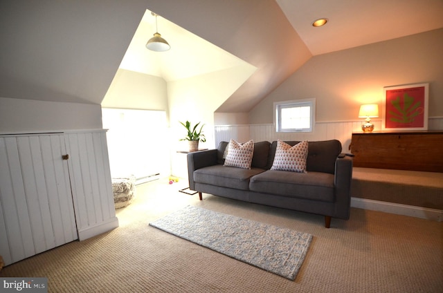 living room featuring lofted ceiling, a baseboard radiator, and carpet