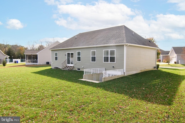 rear view of property featuring a yard