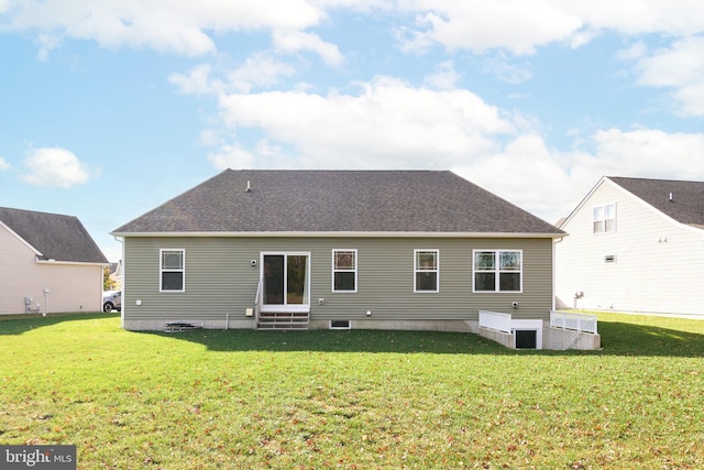 back of house with a lawn