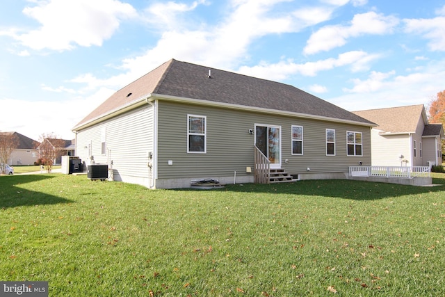 back of property with a lawn and central AC unit