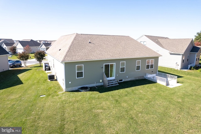 back of house featuring a yard and cooling unit