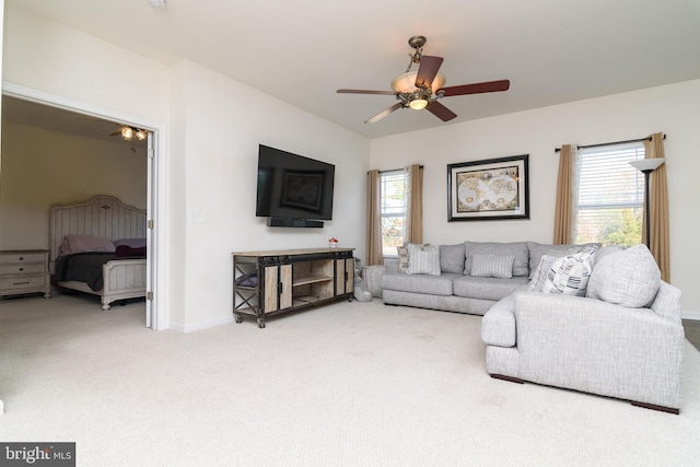 living room featuring carpet, ceiling fan, and a wealth of natural light