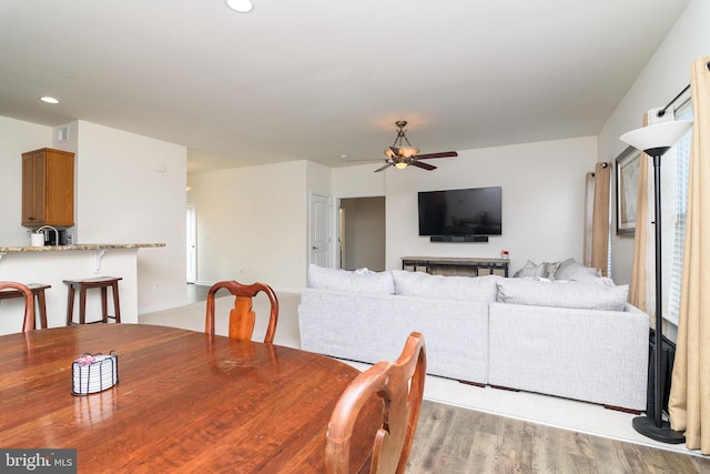 dining room with ceiling fan and light wood-type flooring