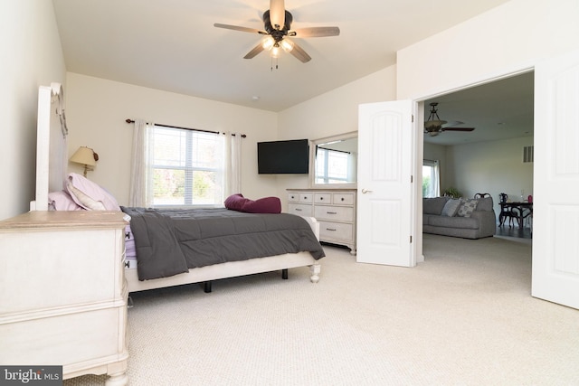 carpeted bedroom with ceiling fan and lofted ceiling