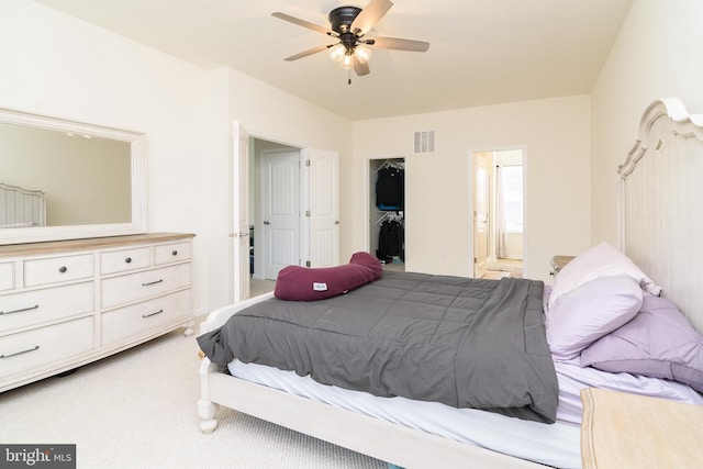 bedroom with carpet, ensuite bathroom, and ceiling fan