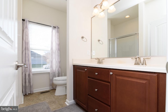 bathroom featuring walk in shower, tile patterned flooring, vanity, and toilet