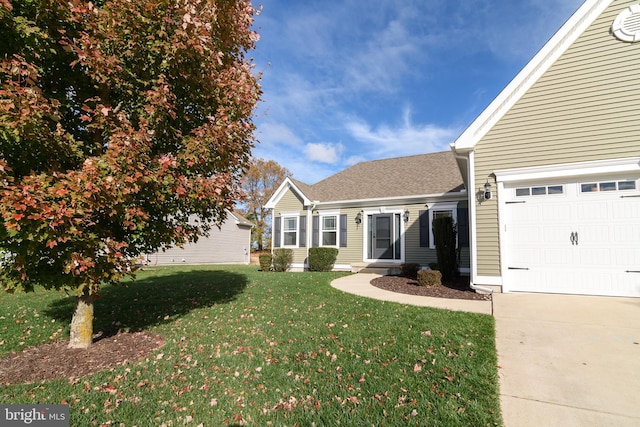 view of front of property featuring a garage and a front lawn