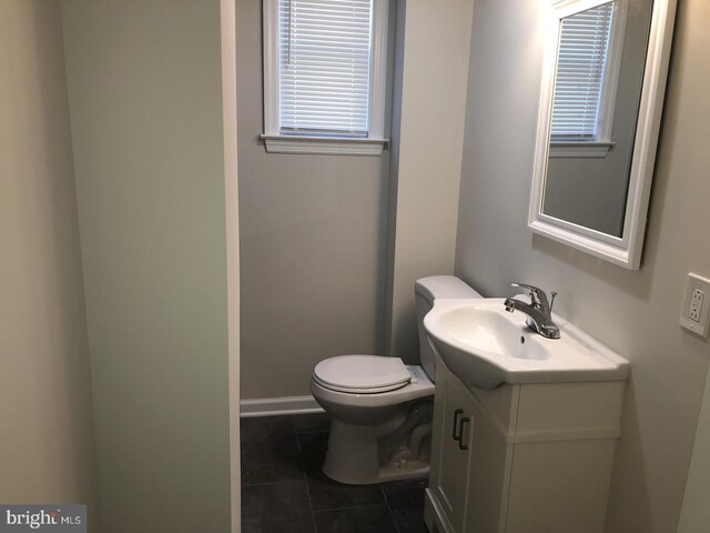 bathroom with vanity, toilet, and tile patterned floors