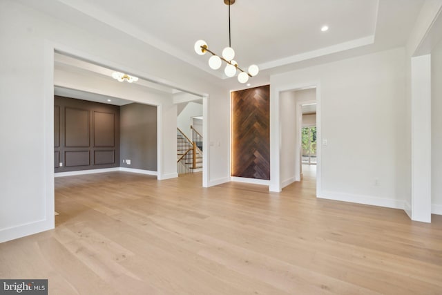 interior space featuring light wood-type flooring and an inviting chandelier