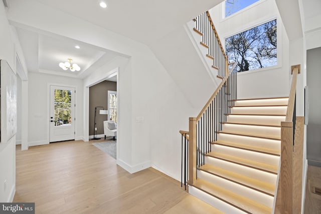 foyer featuring an inviting chandelier and light hardwood / wood-style floors