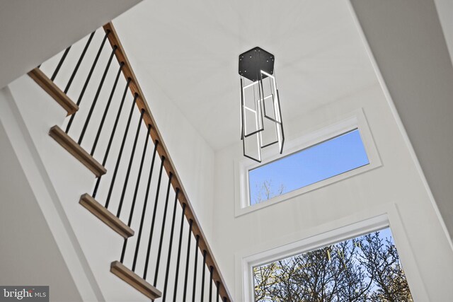 staircase featuring a towering ceiling