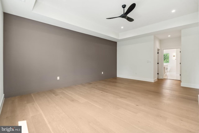 empty room with ceiling fan and light wood-type flooring