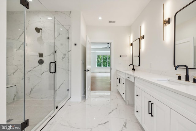 bathroom featuring vanity and an enclosed shower