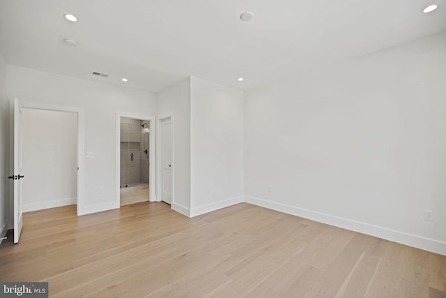 unfurnished bedroom featuring light hardwood / wood-style flooring and ensuite bathroom