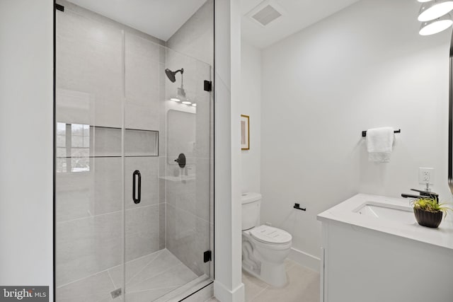 bathroom featuring vanity, tile patterned floors, toilet, and walk in shower