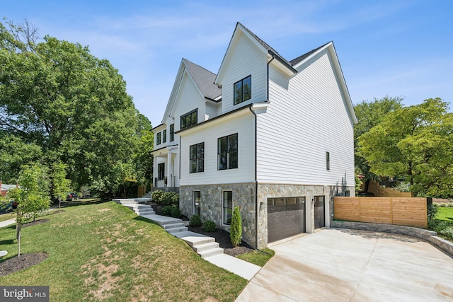 view of front of property with a front lawn and a garage