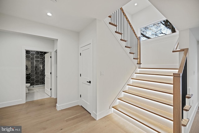 staircase with hardwood / wood-style flooring