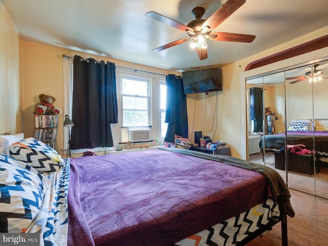 bedroom featuring carpet floors, radiator, ceiling fan, and a closet