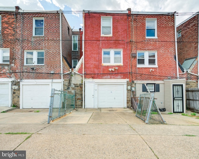 rear view of property with a garage