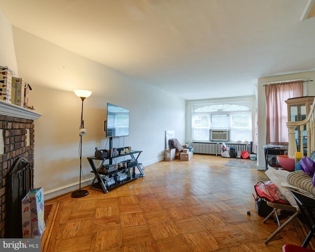 interior space with a brick fireplace, radiator heating unit, and light parquet floors