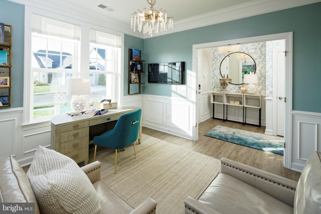 home office featuring light hardwood / wood-style flooring, crown molding, and an inviting chandelier