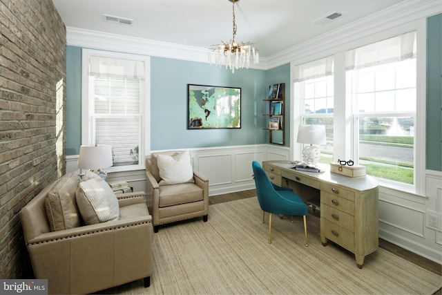 home office with a notable chandelier, light wood-type flooring, and ornamental molding