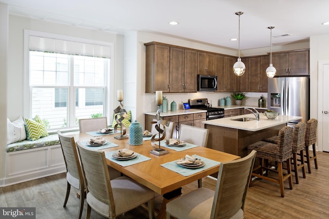 dining space featuring sink and hardwood / wood-style flooring