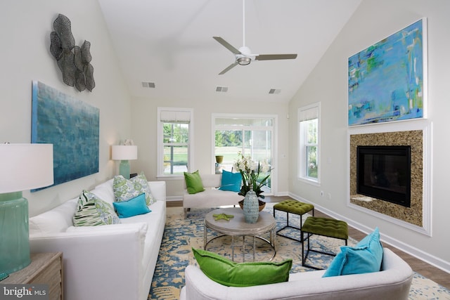 living room featuring ceiling fan, high vaulted ceiling, and hardwood / wood-style floors