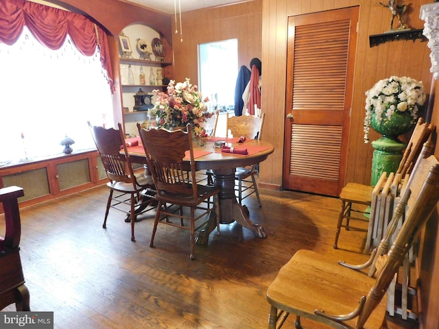 dining space with dark hardwood / wood-style flooring and a wealth of natural light