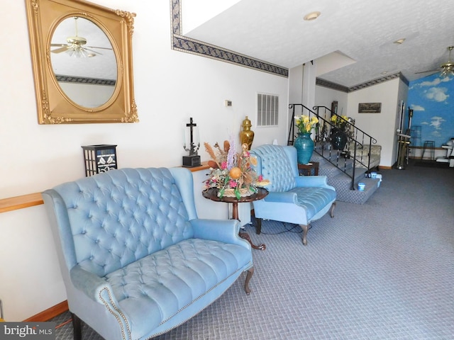 sitting room featuring carpet flooring, a textured ceiling, and ceiling fan