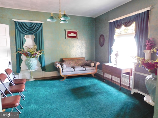 sitting room with carpet flooring and an inviting chandelier